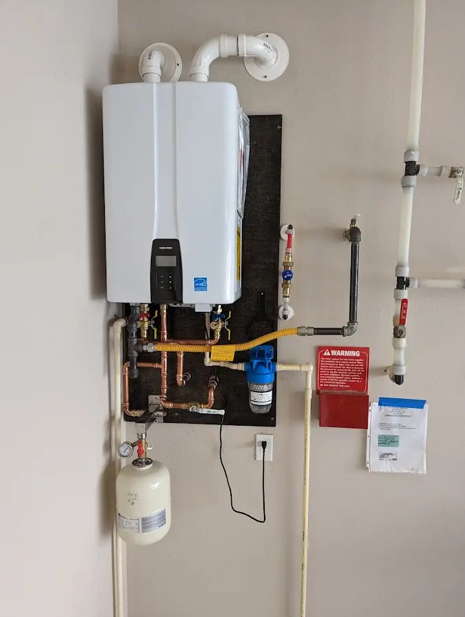 Professional plumber installing copper piping in a Hoboken home